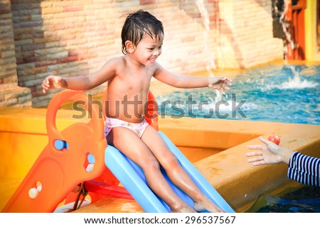 happy funny boy palying swimming pool