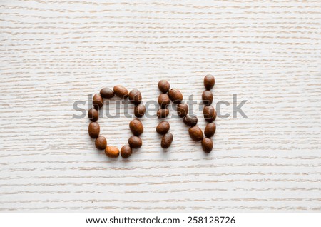 coffee beans on a white table sets out the inscription on
