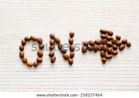 label to include with coffee beans and cinnamon on a white table