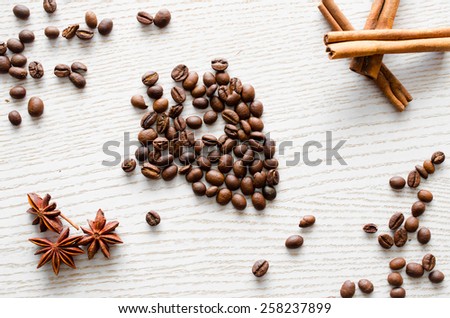 label to include with coffee beans and cinnamon on a white table