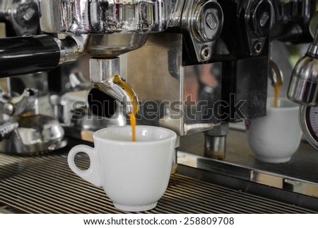 cooked cup of espresso coffee machine is on