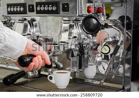 cooked cup of espresso coffee machine is on