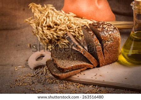 still life of bread and millet in old style on a linen cloth with a distinct texture. The figure also oil and grain cereals and eggs.