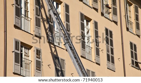 Ladder used to move furniture with elegant palace in background