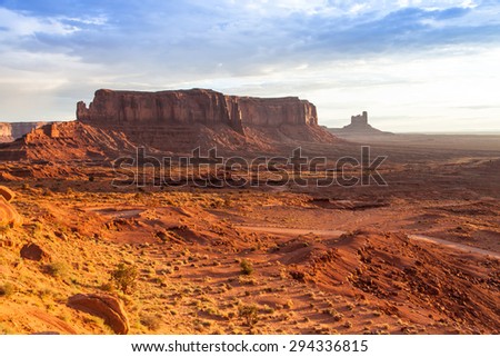 Orange colours during sunrise in this iconic view of Monument Valley, USA