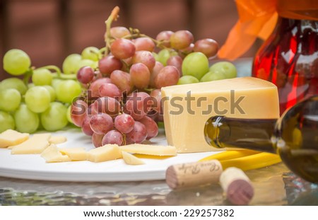 Grapes cheese and empty wine bottle