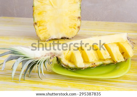 Quarter of cut pineapple On slate dish.