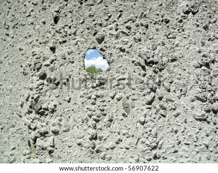 Hole in a concrete wall with crack background texture