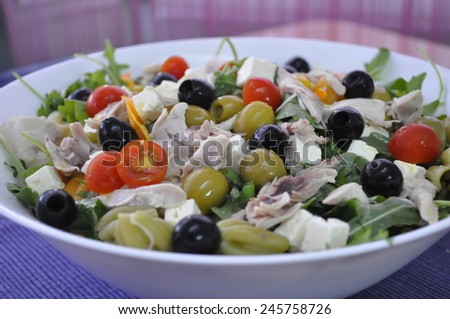 Mediterranean salad with chicken, cheese, pasta and black olives