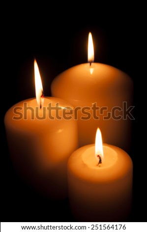 calm, bright, can be romantic or festive light candles on a black background. The light in the darkness.