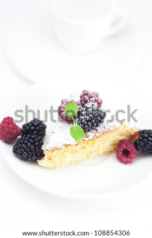 cup, cake, raspberry, blackberry and mint on a plate on a white background