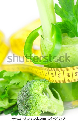 measuring tape,broccoli,pepper,celery and glass with celery juice isolated on white