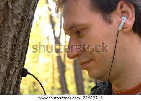 man in headphones, in the woods
