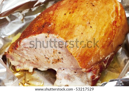 large piece of meat in foil with spices