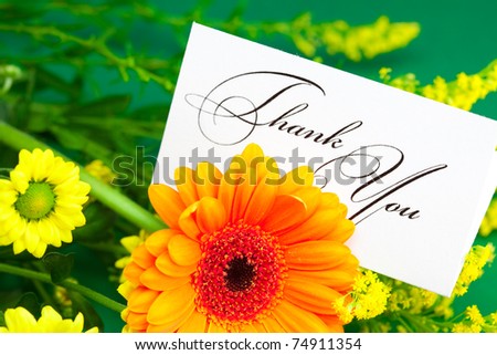 yellow daisy,gerbera and card signed thank you on green background