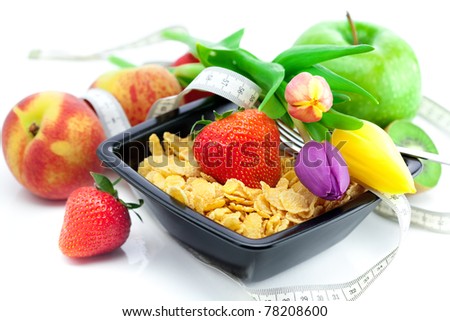strawberry, peach, apple, kiwi fruit, tulips and flakes in a bowl isolated on white