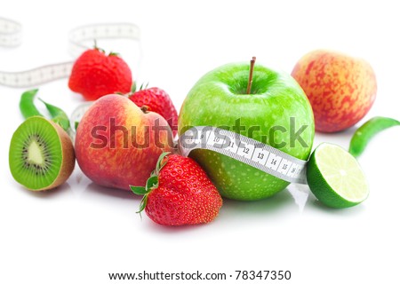 big juicy red ripe strawberries,apple,lime,peach,kiwi  and measure tape isolated on white