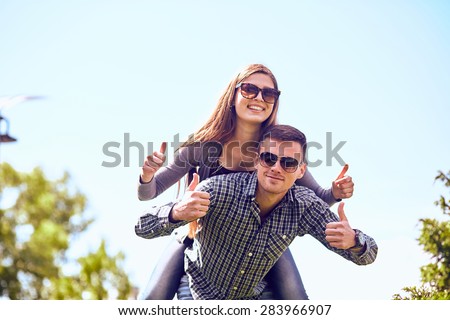 Holidays, vacation, love and friendship concept - smiling couple having fun in city