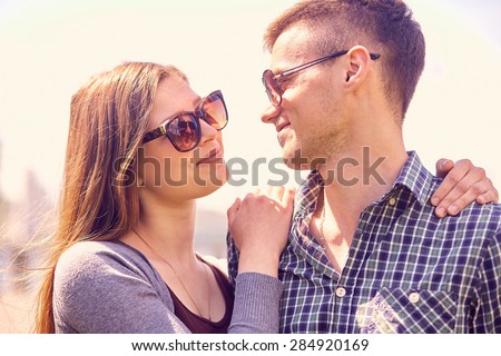 Holidays, vacation, love and friendship concept - smiling couple having fun outdoors