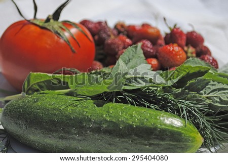 cucumber, dill, mint, tomato, strawberry on a white plate