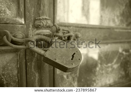 Old Rusted Lock Secured on Crypt Door