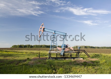 Oil and gas industry. Work of oil pump jack on a oil field.