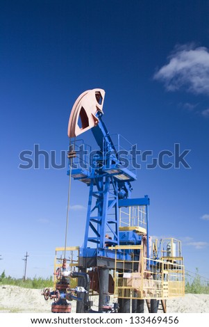 Oil and gas industry. Work of oil pump jack on a oil field in desert