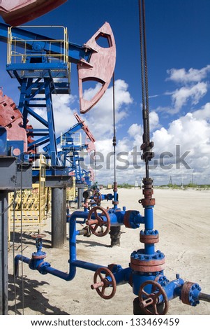 Oil and gas industry. Work of oil pump jack on a oil field. Oil latch on a pipeline