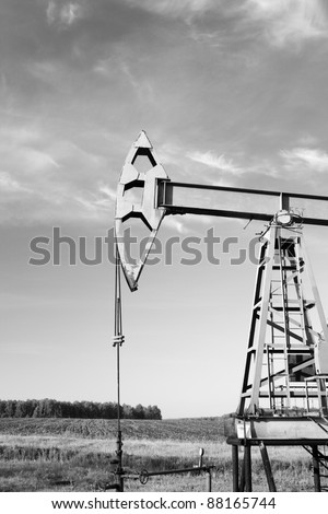 Oil and gas industry. Work of oil pump jack on a oil field. Black and white photo