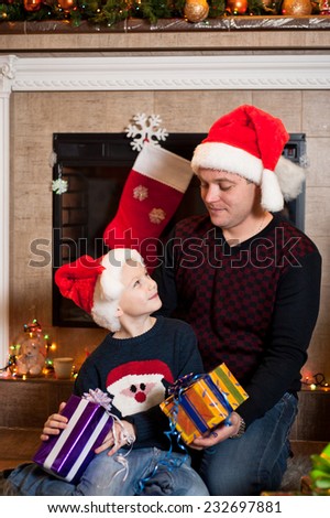 Father gives his son a Christmas gift