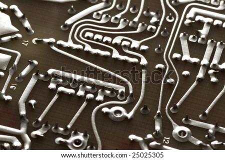 Close up of a soldered circuit board with various paths and patterns