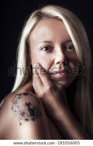Blonde woman with tattoo with no make up