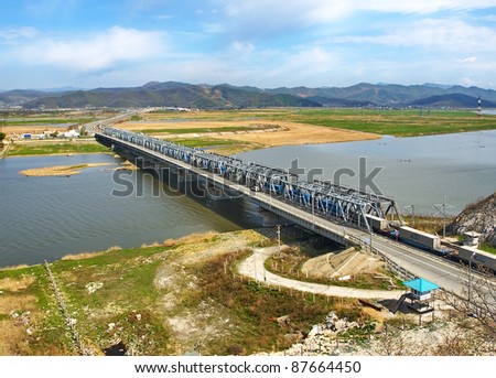 Railway bridge through the river Partizanskaya (Primorsky krai, Russia) with the moves on him freight train.