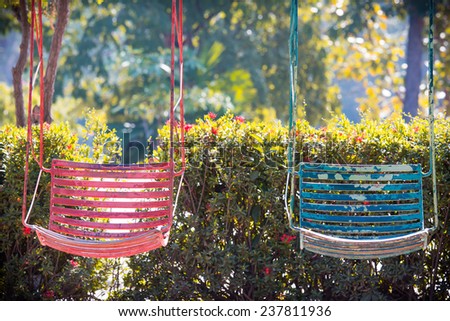 Colorful old  and rusty iron swings on playground