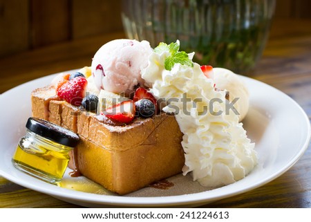 Honey toast with whipped cream,ice cream and mix berry