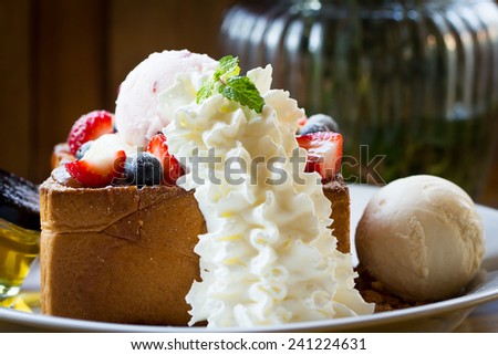 Honey toast with whipped cream,ice cream and mix berry