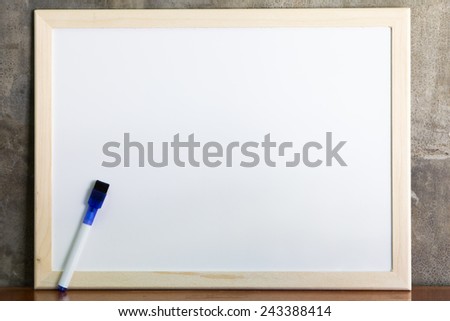 Whiteboard and marker on cement wall background
