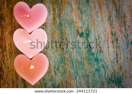 Candle heart shape on wood table in vintage style