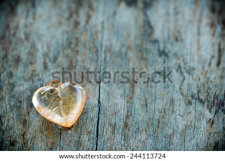 Crystal heart on wood table in vintage style