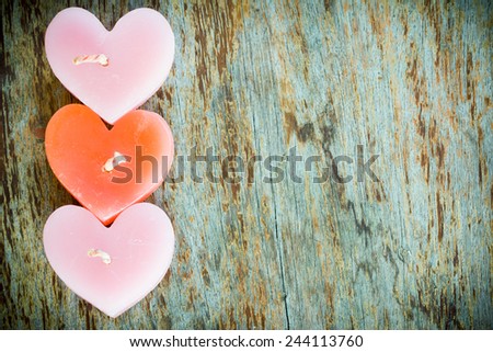 Candle heart shape on wood table in vintage style