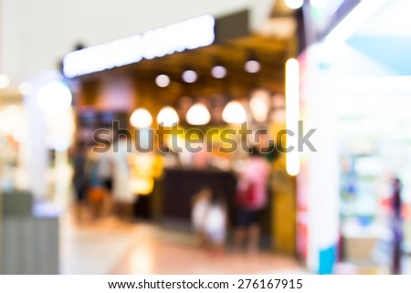 Blurred image of coffee shop in airport with bokeh for background usage