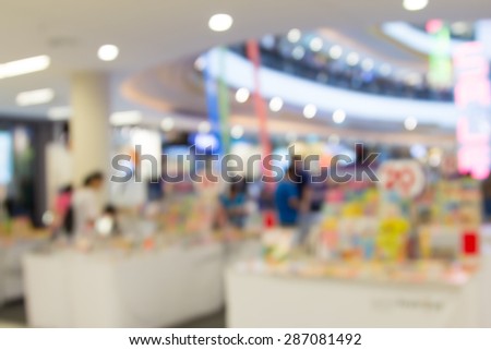 blur image of book shop in shopping mall with people