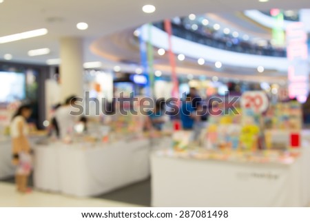 blur image of book shop in shopping mall with people