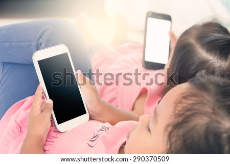two kids hold smart phone,tablet,cellphone for playing and education together,soft color effect