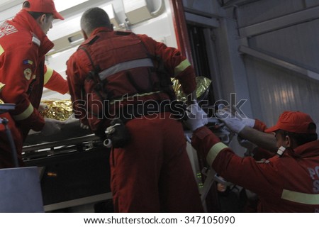 Bucharest, Romania, October 31, 2015: Romanian paramedics transfer a wounded person, who survived from a fire at a Colectiv Club from the Emergency Hospital Floreasca to a burn center.