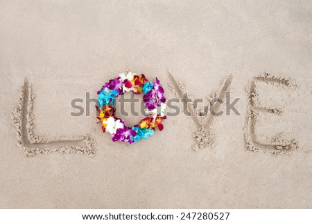 Bright diadem with exotic flowers on the sand