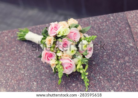 Beautiful wedding colorful nosegay of pink and peach roses