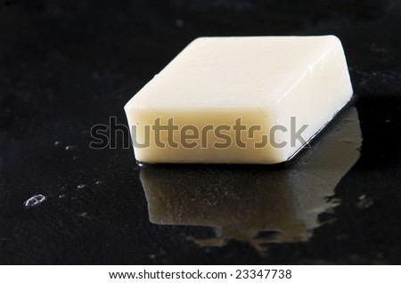 bar of white soap on wet black slate