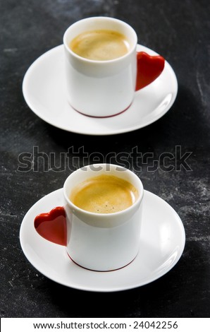 Espresso served on heart shaped cup on black slate