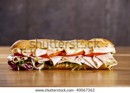 Turkey sandwich with cheese lettuce and tomato